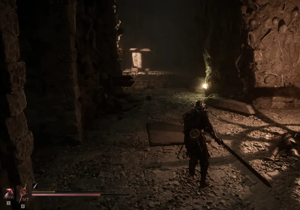 Player advances through a torchlit rubble-strewn passage toward a doorway with HUD visible