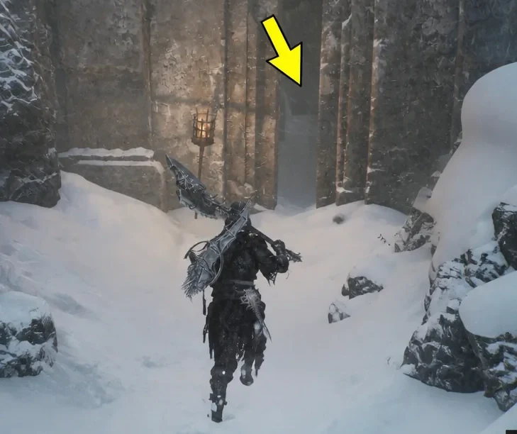 Armored Harbinger walking toward a stone doorway through a snowy passage in the Conquered Temple