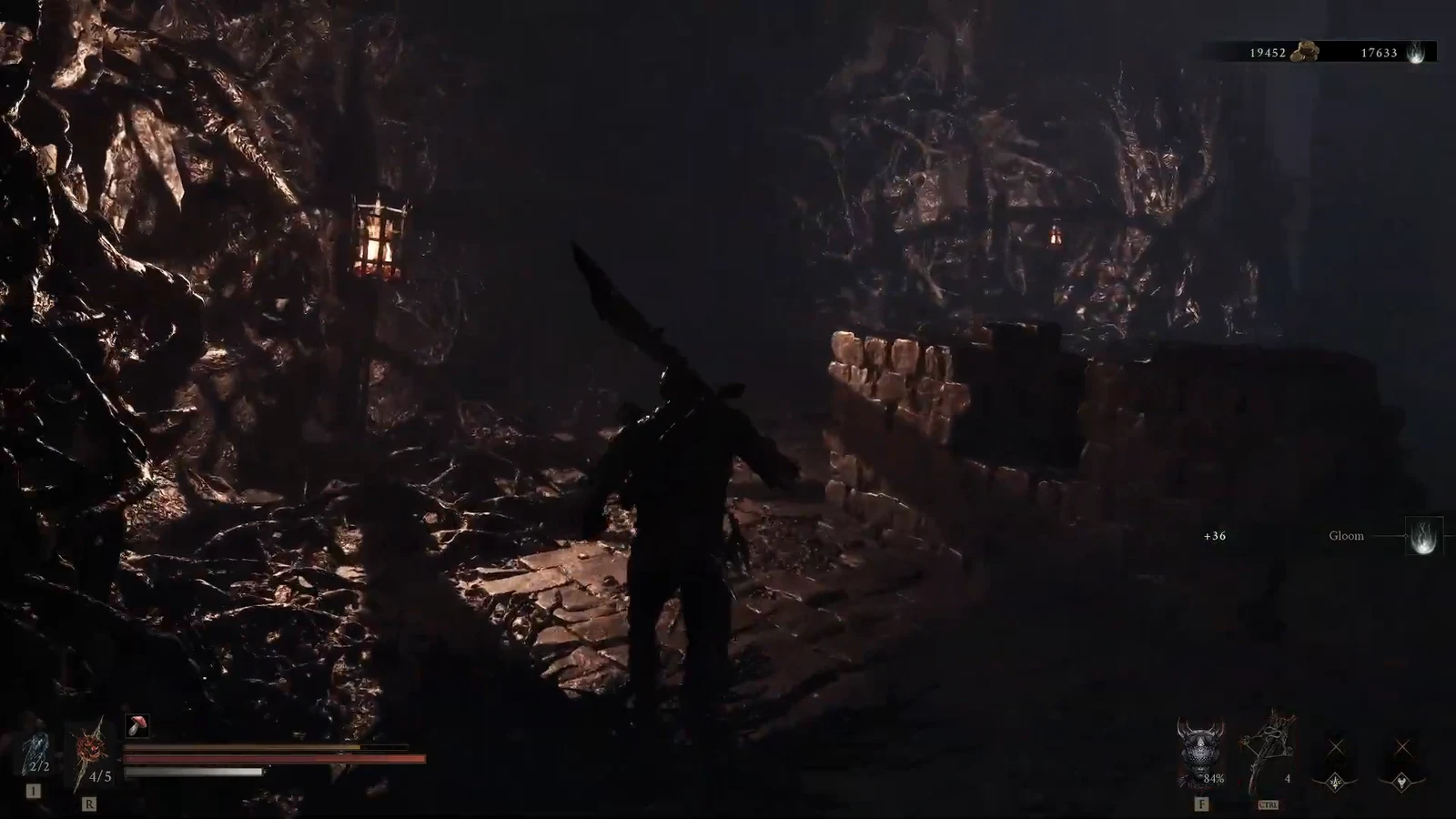 Armored character walking a dark cavern path beside a stone barricade