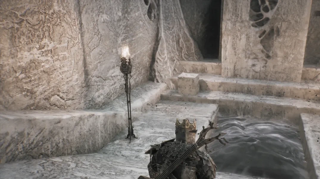 Opened doorway revealed behind the large statue beside the first boss arena