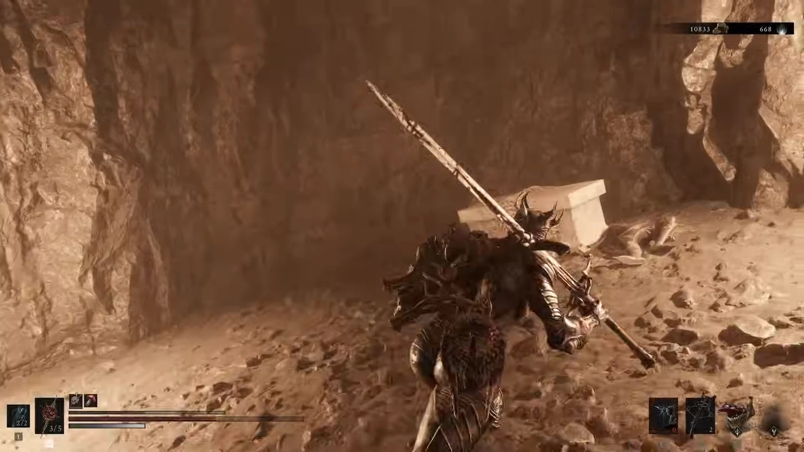 Harbinger holding a greatsword while moving through a rocky canyon on the way to the sarcophagus