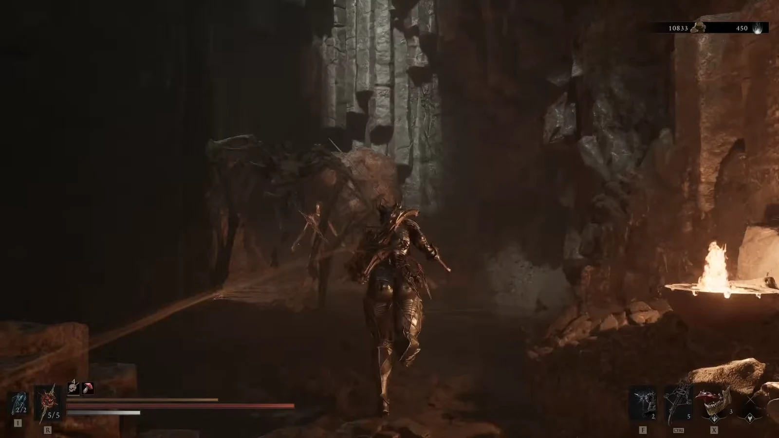 Harbinger advancing through the dark cavern toward an enemy with the combat HUD visible
