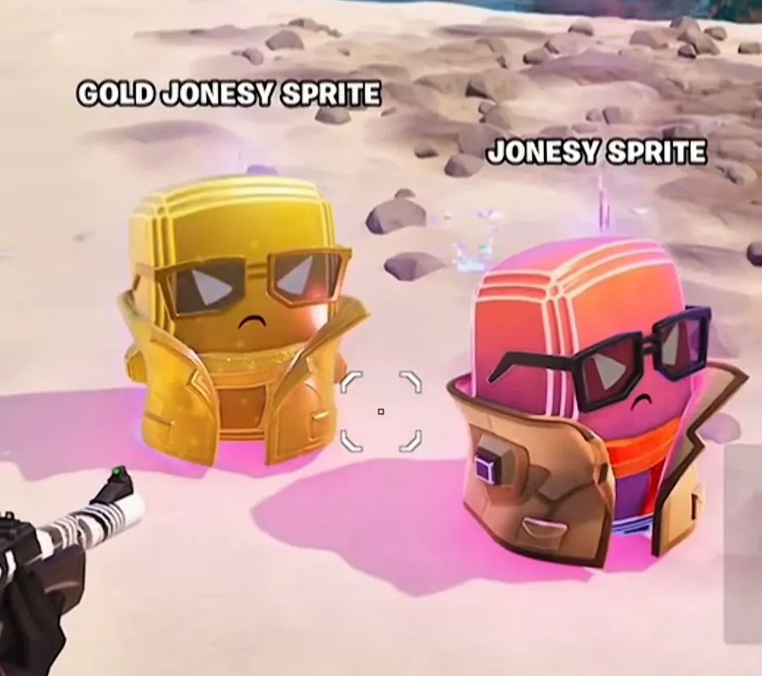 Gold Jonesy Sprite and standard Jonesy Sprite standing side by side on a beach