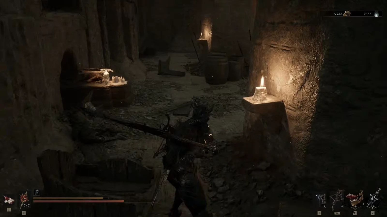 Player carrying a large crossbow while exploring a candlelit chamber inside the Abandoned Shrine