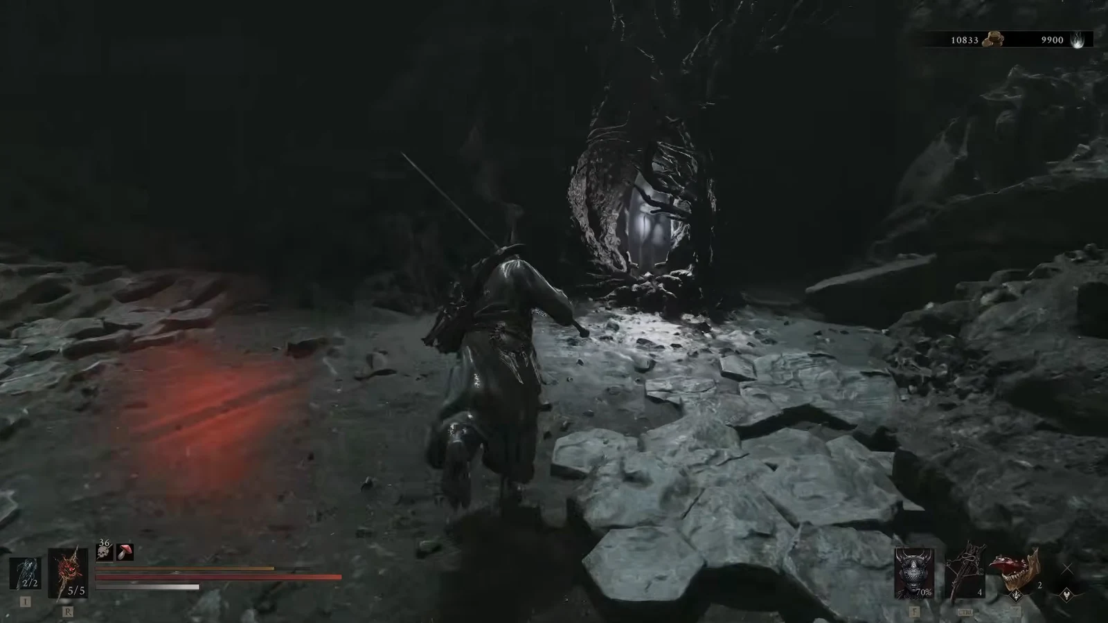 Armored Harbinger crosses a rocky cavern toward a lit opening with health and resource counters on screen