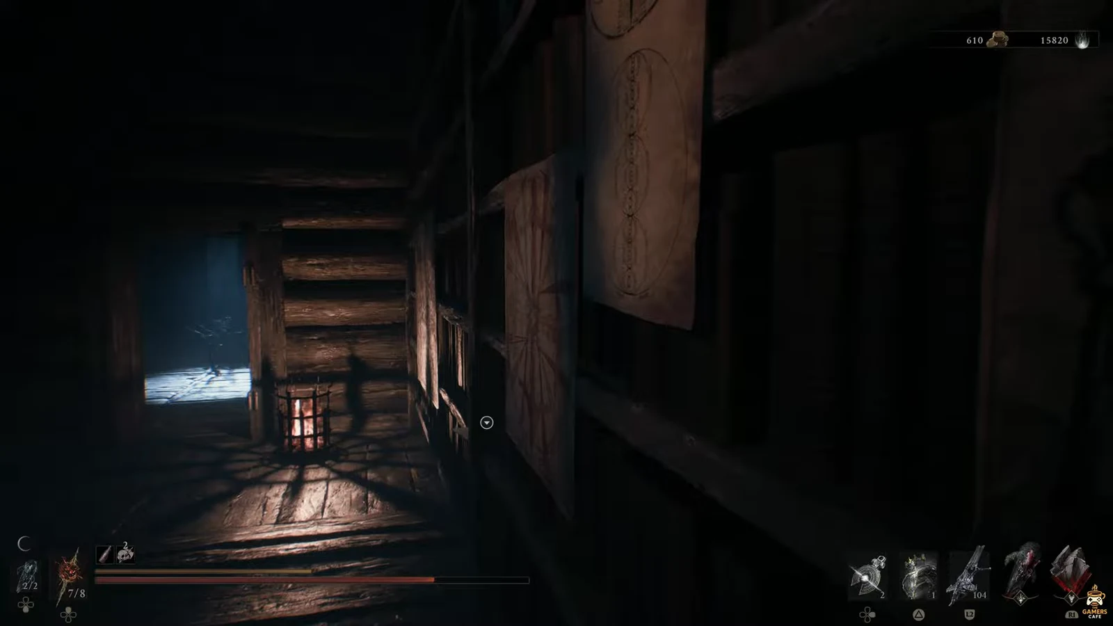 First-person view of a dark wooden passage with the reticle beside a hanging scroll