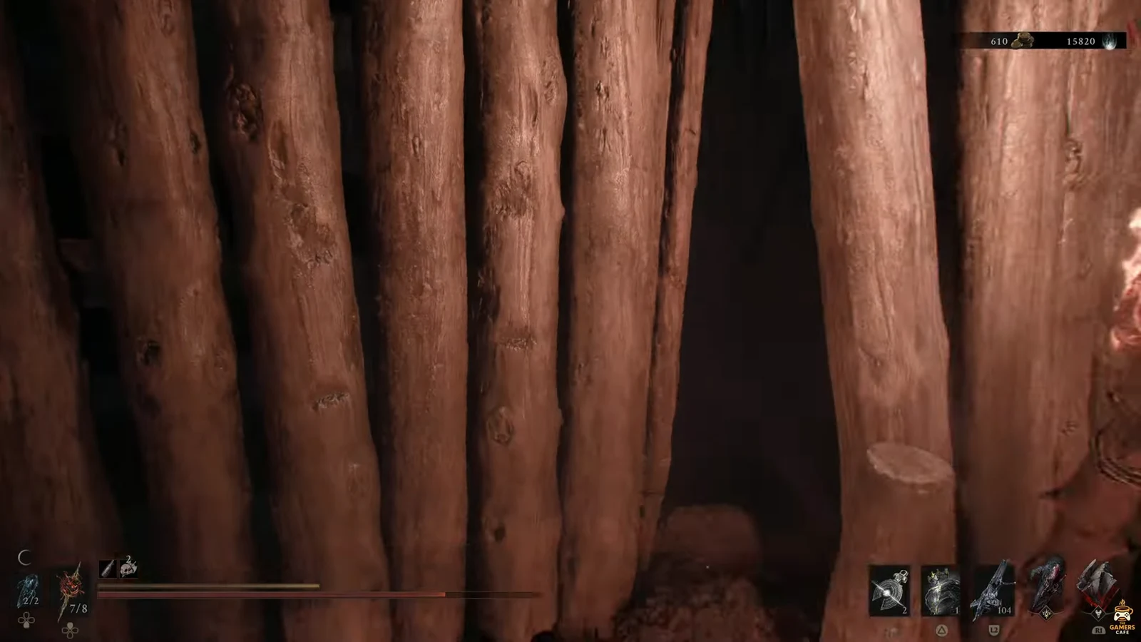 First-person view pressed against a wooden palisade with the combat HUD up