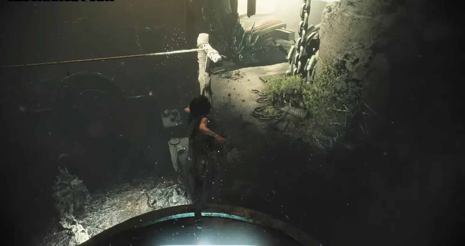 Sophia crossing a narrow ledge next to a rope and large machinery at a Resonance Point