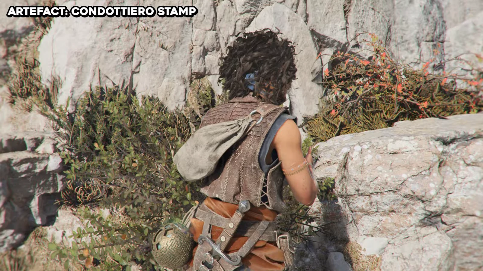 Cliffside path where the Condottiero Stamp Artefact rests on the ground beside a rock