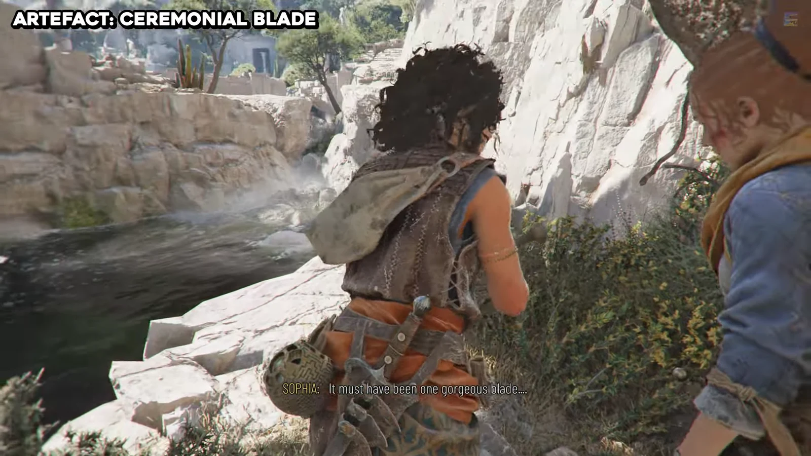 Sophia inspecting the Ceremonial Blade Artefact found under a tree on the cliffside