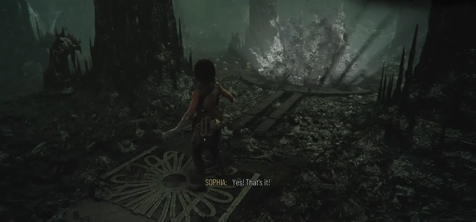 Sophia following the beam through the dark second area toward the circular platform