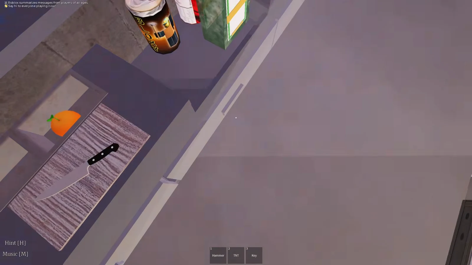 First-person kitchen view with a knife and orange on a cutting board, Hammer, TNT and Key in the hotbar