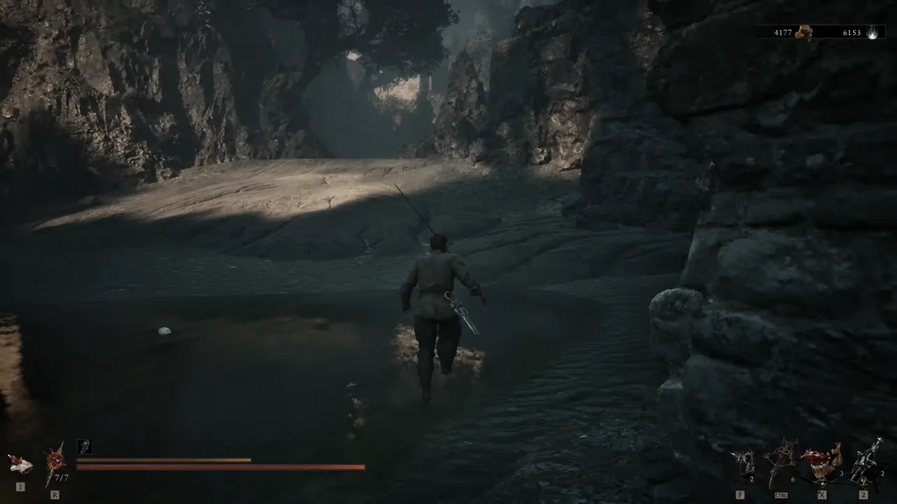 Player wading through a dark cavern with the HUD visible in the Ruins of Nochte