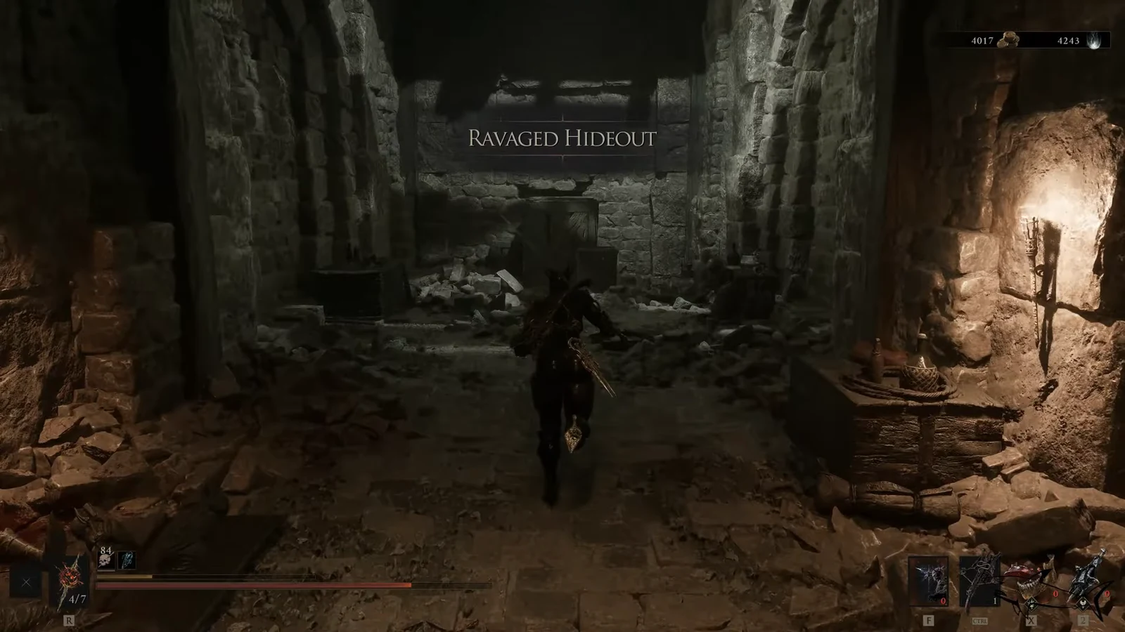 Ravaged Hideout area label as the player moves through a torchlit rubble-filled corridor