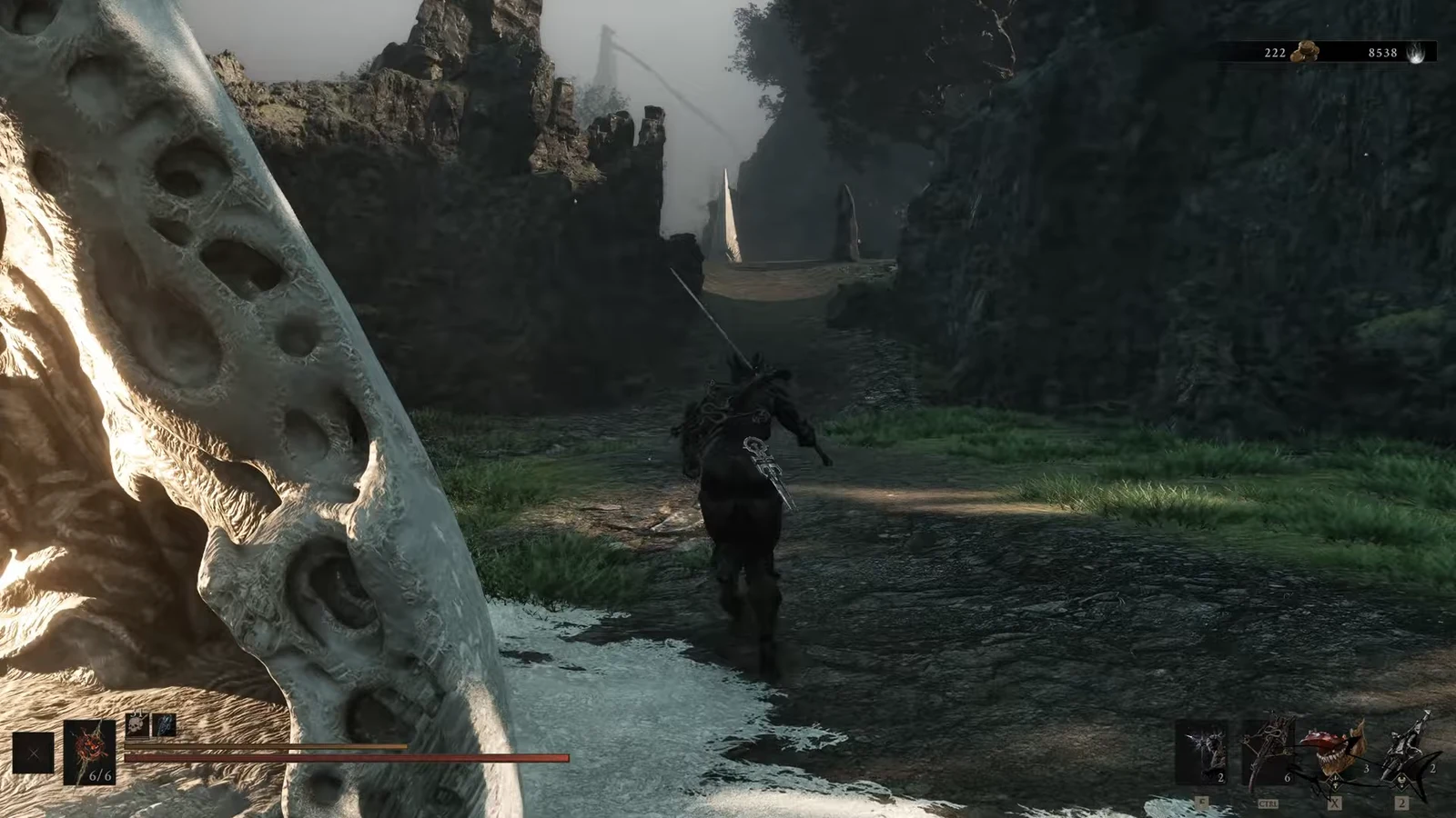 Player character rides through a rocky, grassy ravine toward a stone bridge with the combat HUD visible