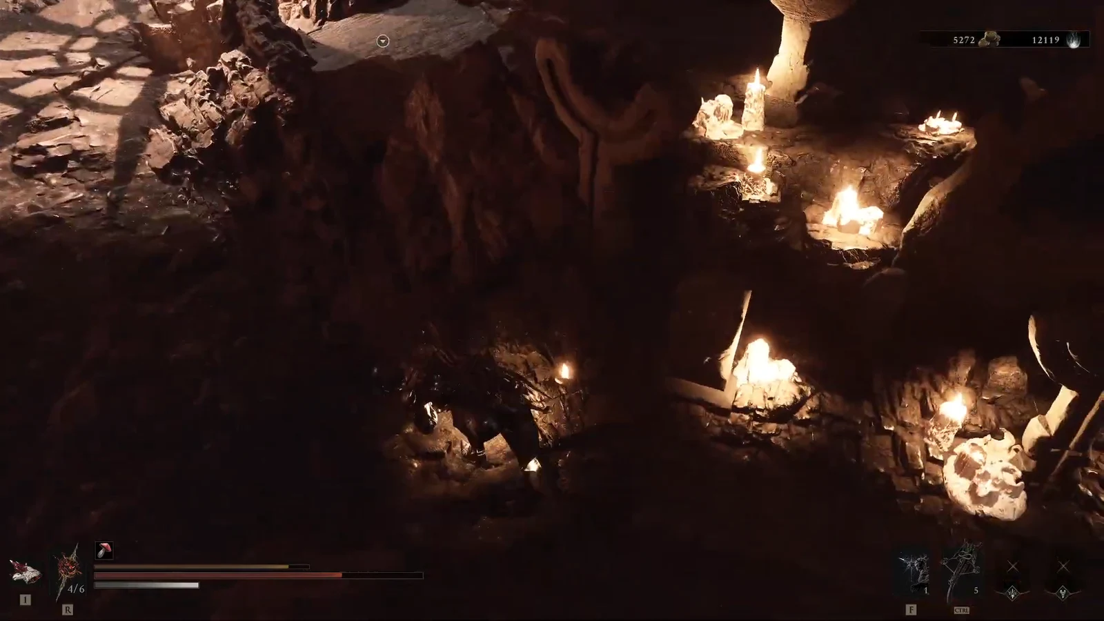 Character standing by a glowing gravestone in the cavern with the gameplay HUD showing health and resources