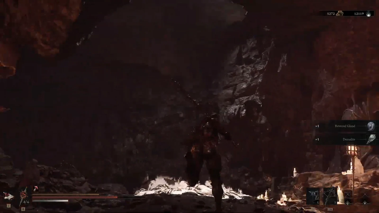 On-screen pickup notifications reading +1 Revered Gland and +1 Dorsalite as loot is collected in the cavern