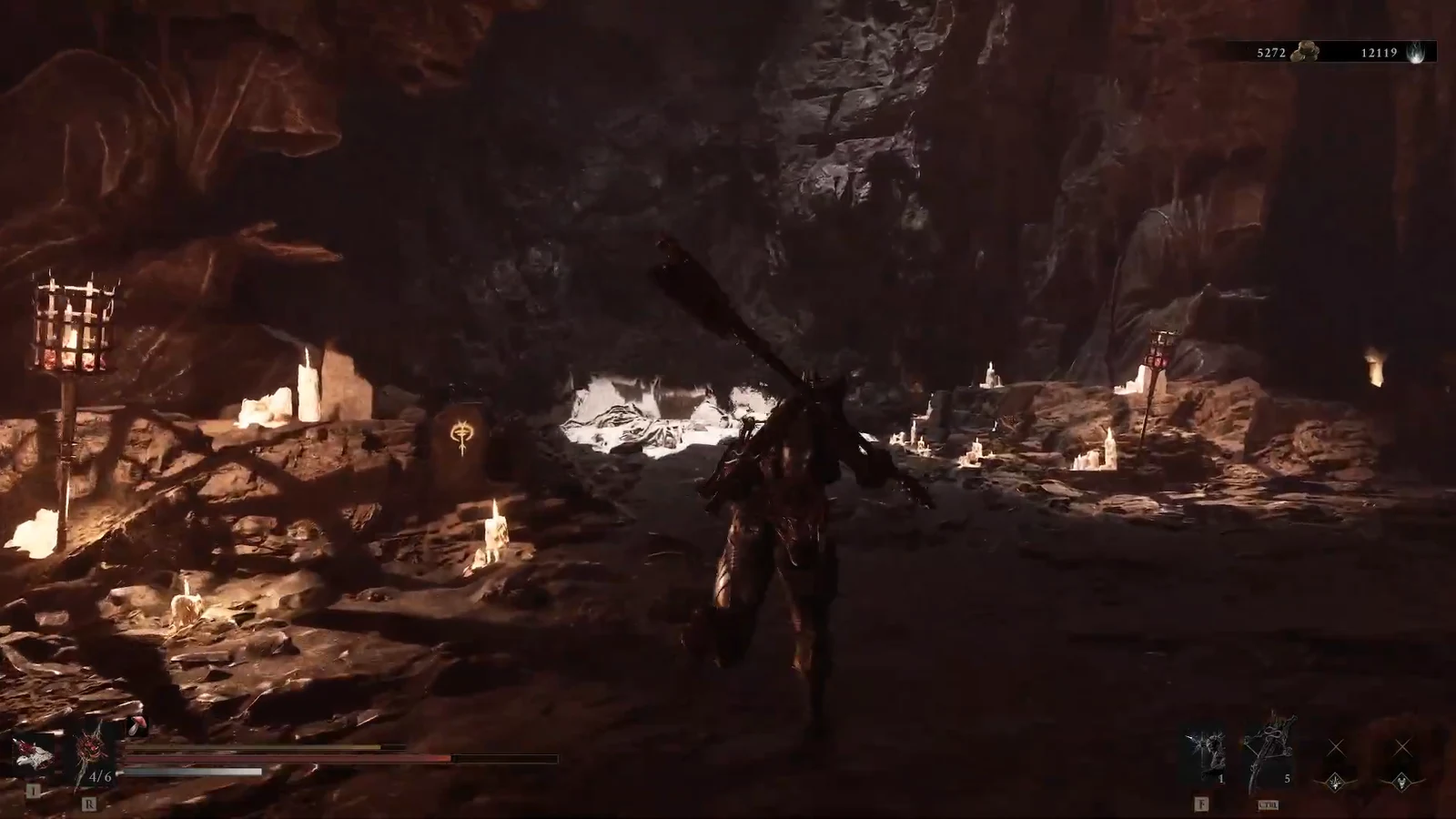 Player character with a large weapon moving through the candlelit cavern at Sester's Refuge