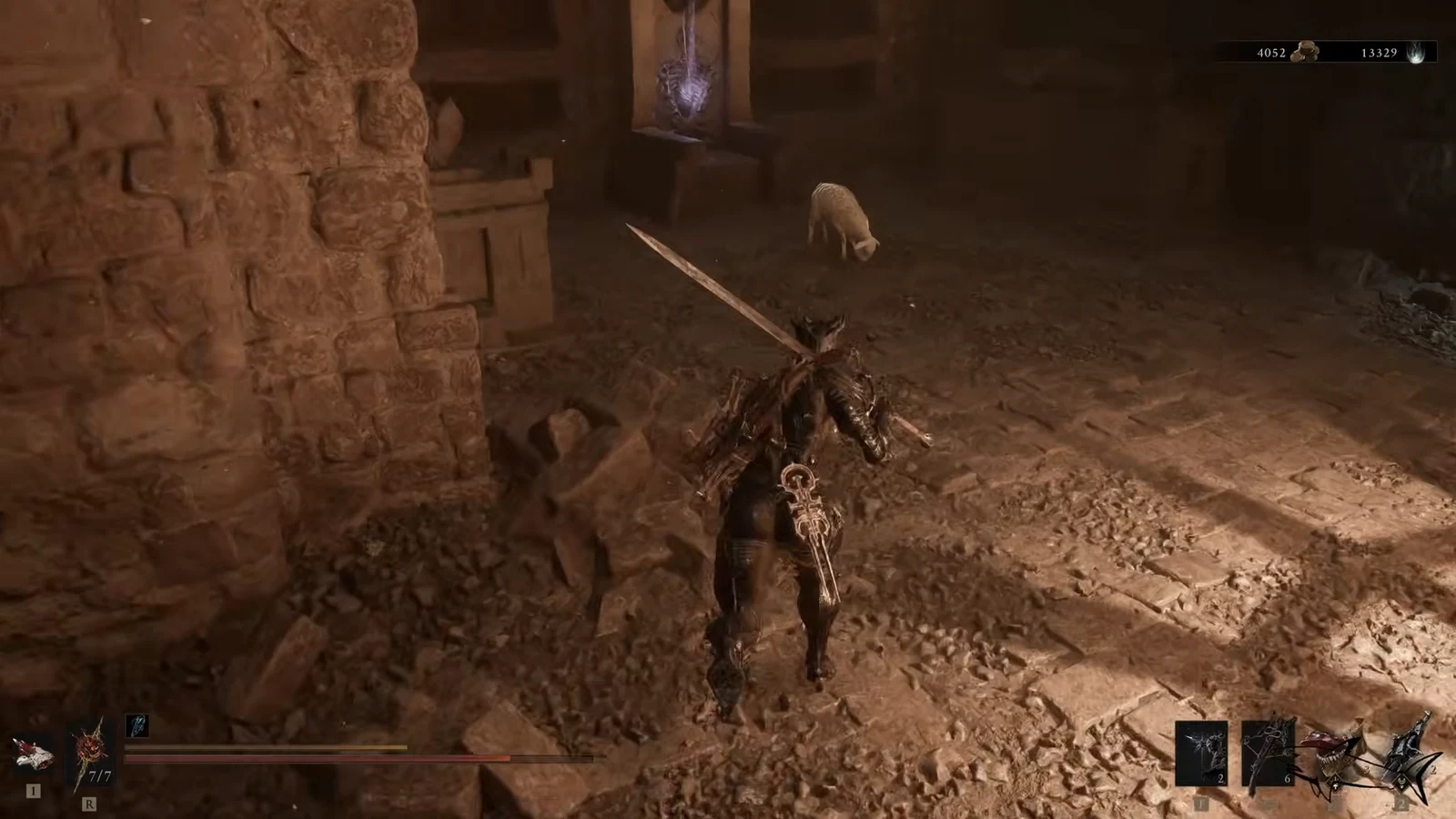 Player closing in on a small enemy inside a ruined stone chamber with sword drawn
