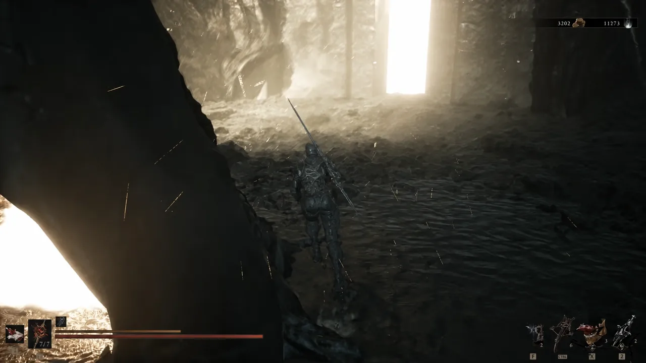 Armored character walking through a dark cavern toward a lit opening beyond the Corrupted Gate