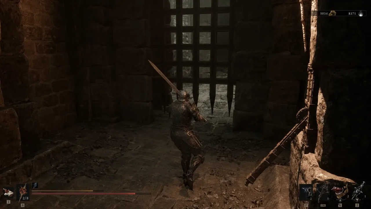 Character standing in a stone corridor facing a closed spiked portcullis gate