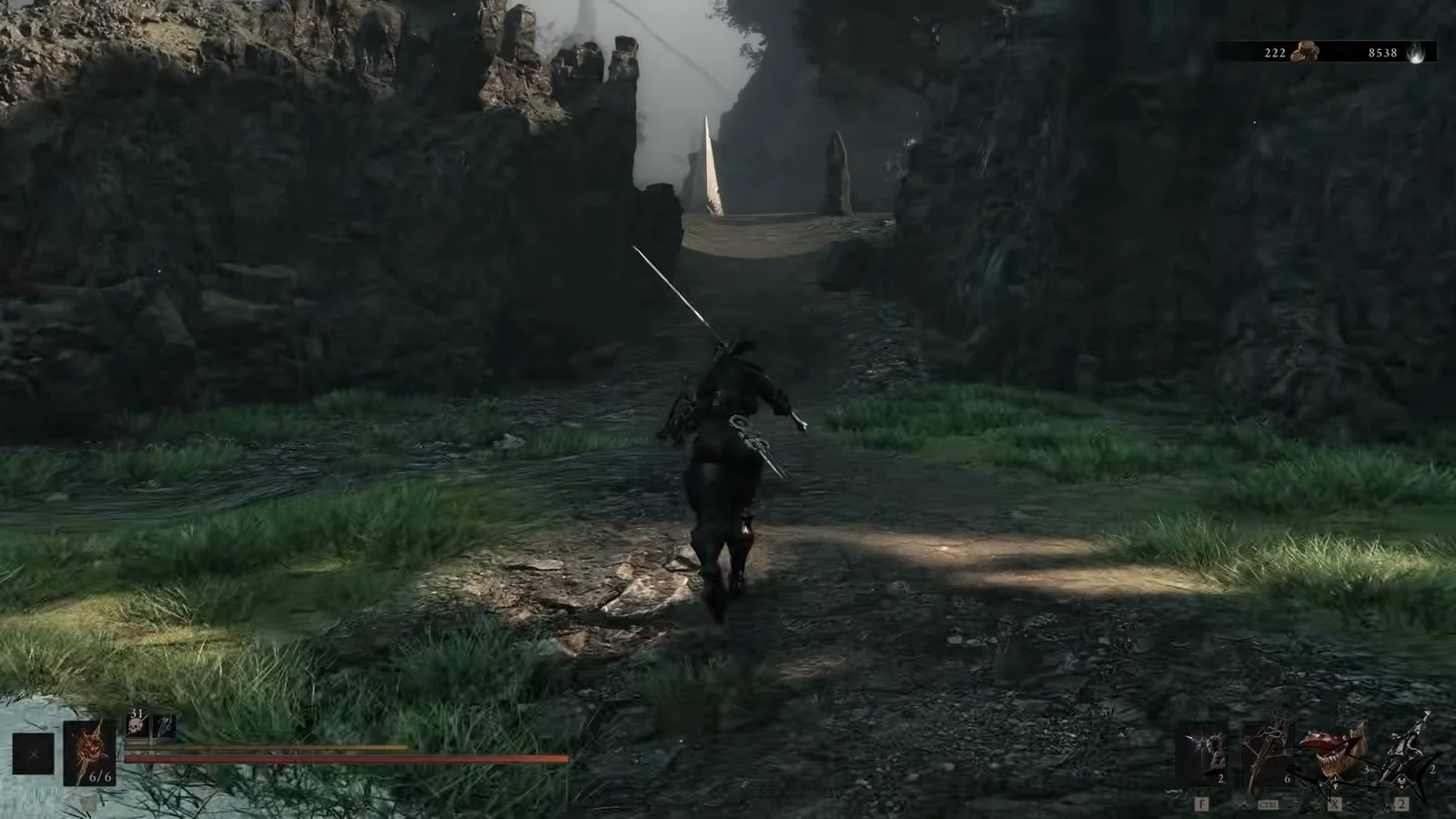 Player character running down a rocky path toward a narrow stone bridge from Widow's Overlook