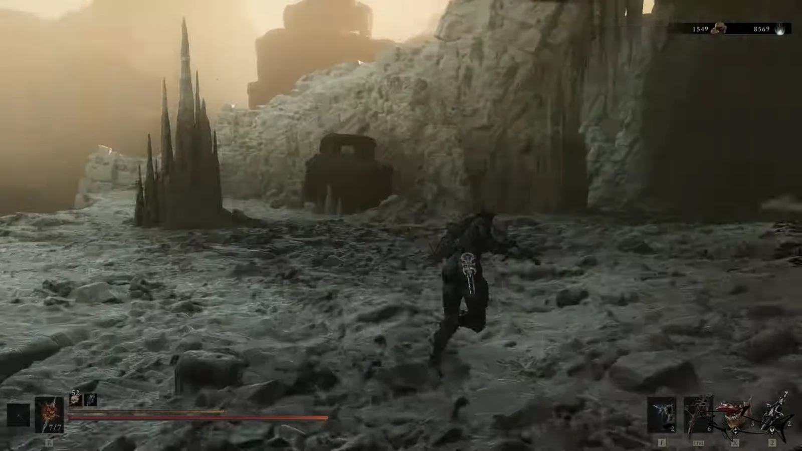 Player character running across snowy rocky ground toward a dark cave entrance
