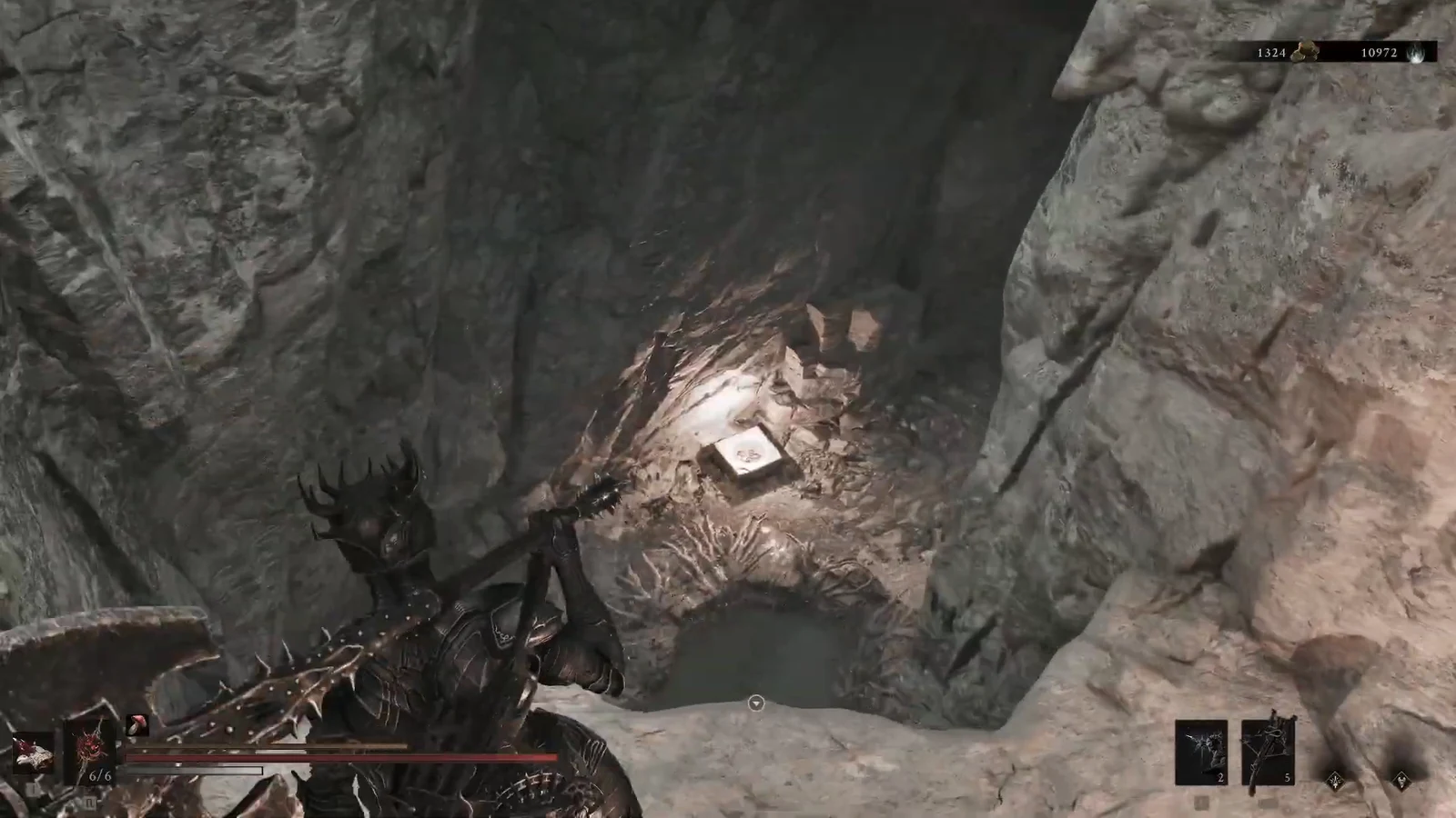Harbinger aiming at a glowing item among bones inside a rocky cavern in Mortal Shell 2