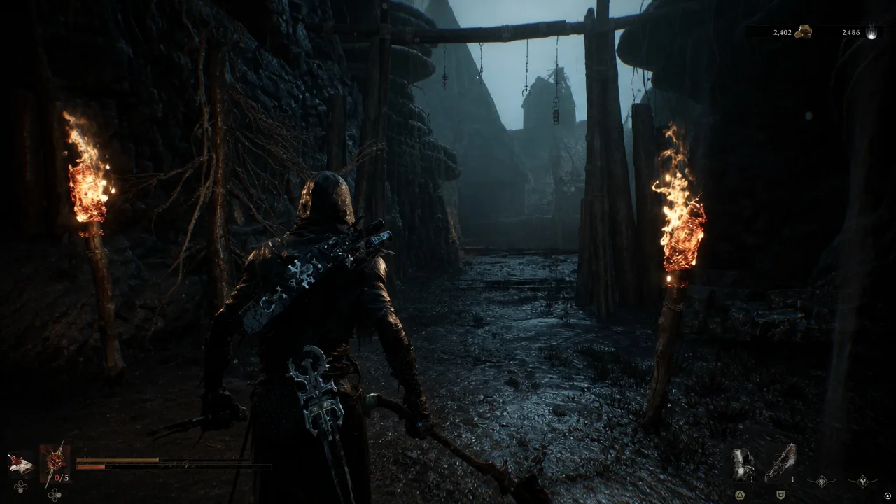 Player character moving weapon-drawn through a torch-lit muddy passage on the way into the Sunken Village