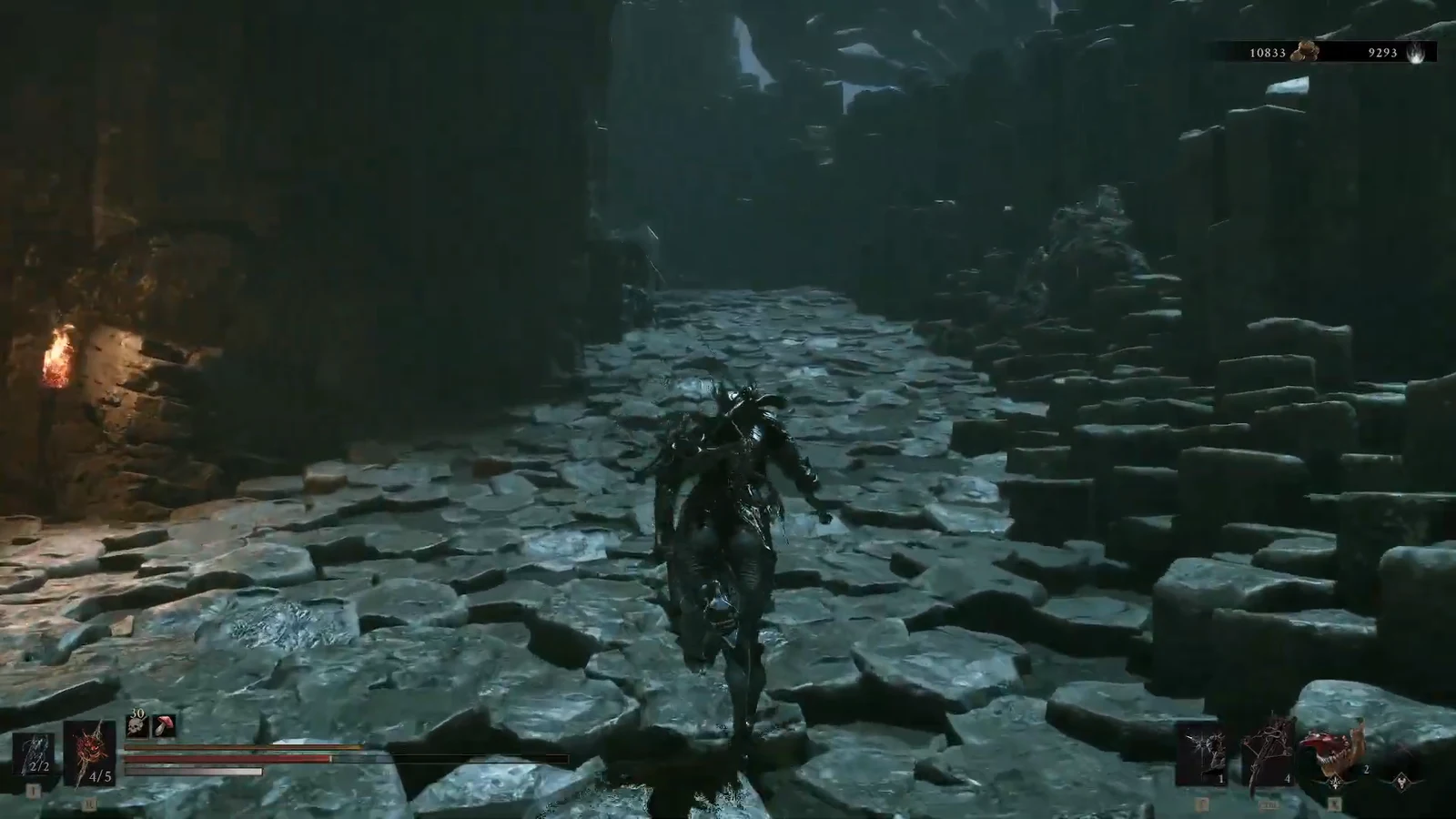 Harbinger moving through a torch-lit stone corridor with HUD visible