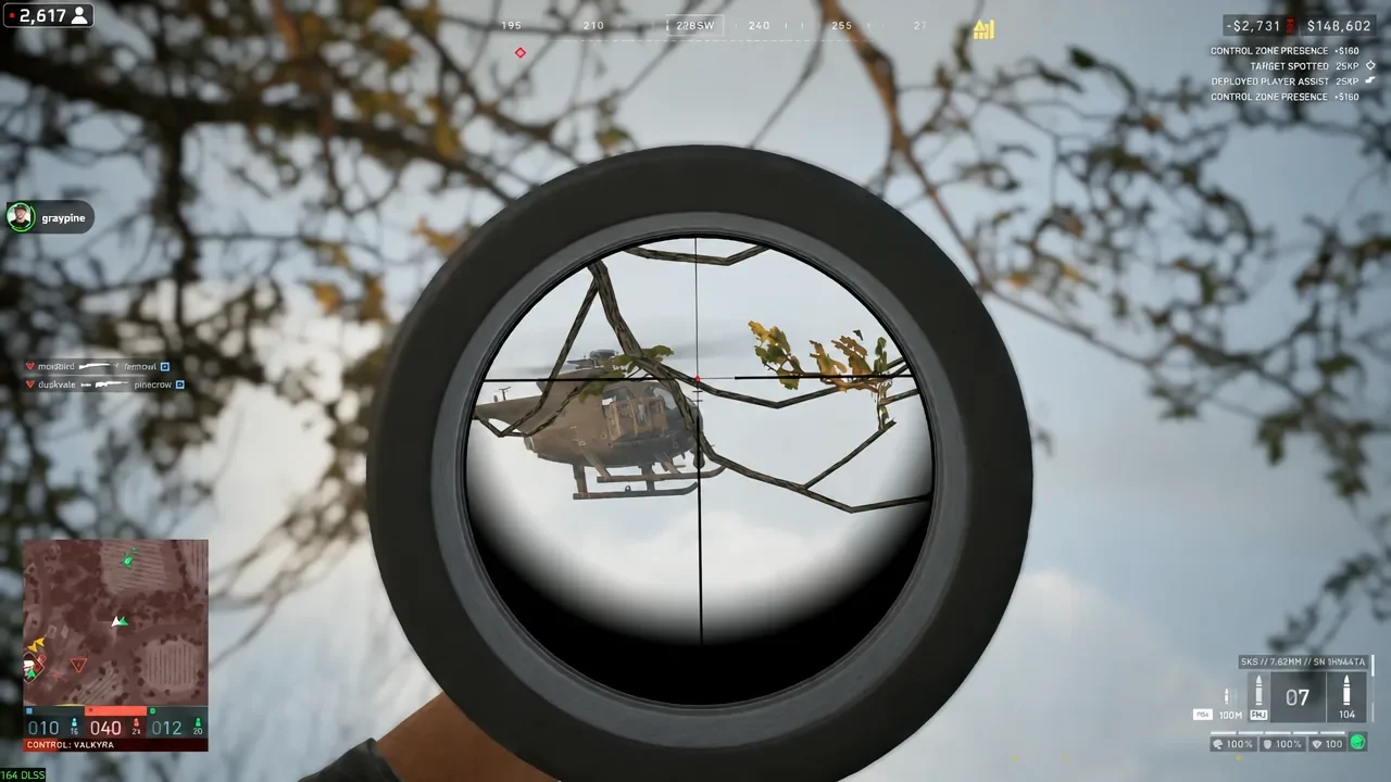 Sniper scope view with the reticle placed on a distant helicopter