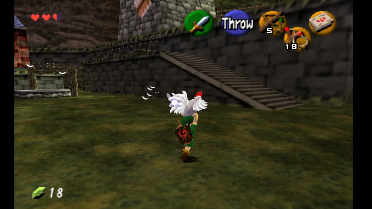 Link carries a Cucco up a stone ramp in Kakariko Village with the Throw prompt on screen