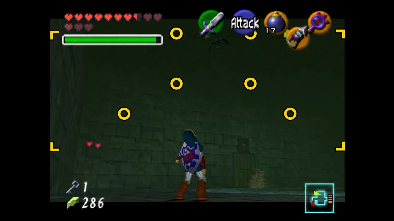 Ocarina of Time combat HUD with the Attack button visible as Link stands in a dungeon
