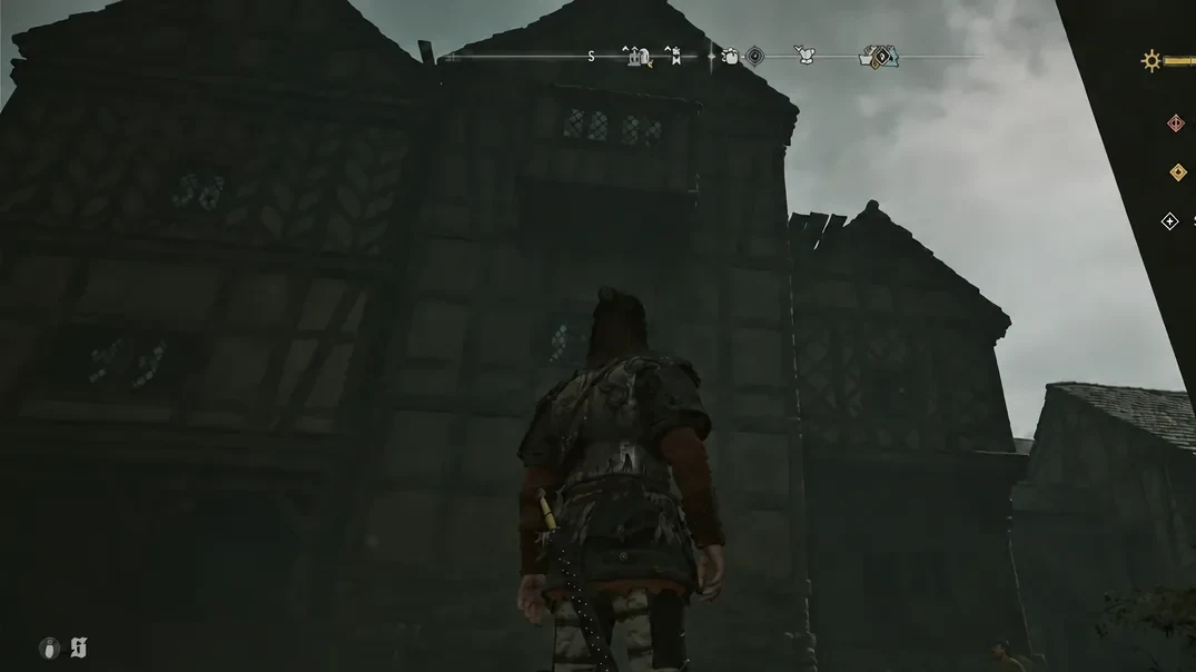 Coen standing in front of a timber-framed house in Svartrau City while searching for a cache