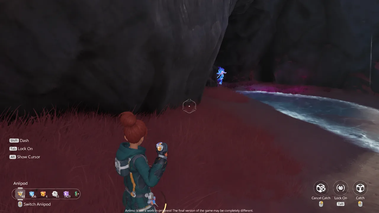 Aiming an Anipod at the glowing Luminelle inside the cave with the Catch prompt on screen