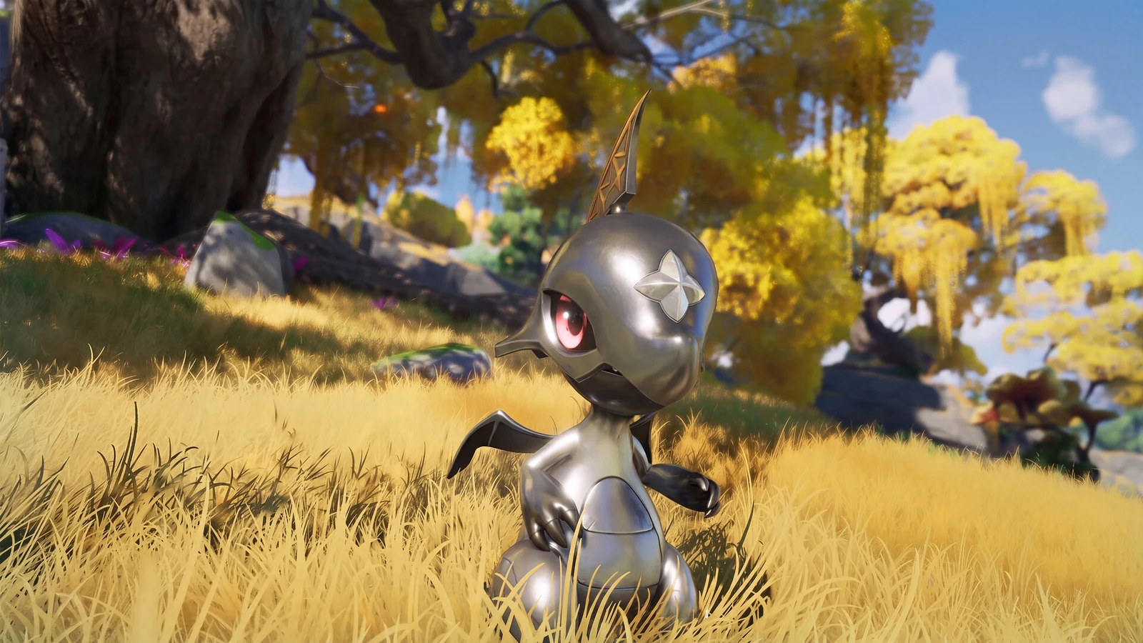 A small black metallic creature with glowing red eyes stands in tall grass beneath autumn trees during daylight.