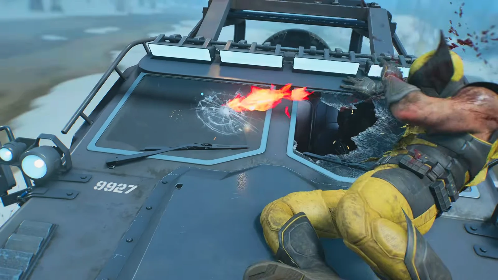 Yellow-suited Wolverine smashing through an armored vehicle windshield as flames and glass burst outward
