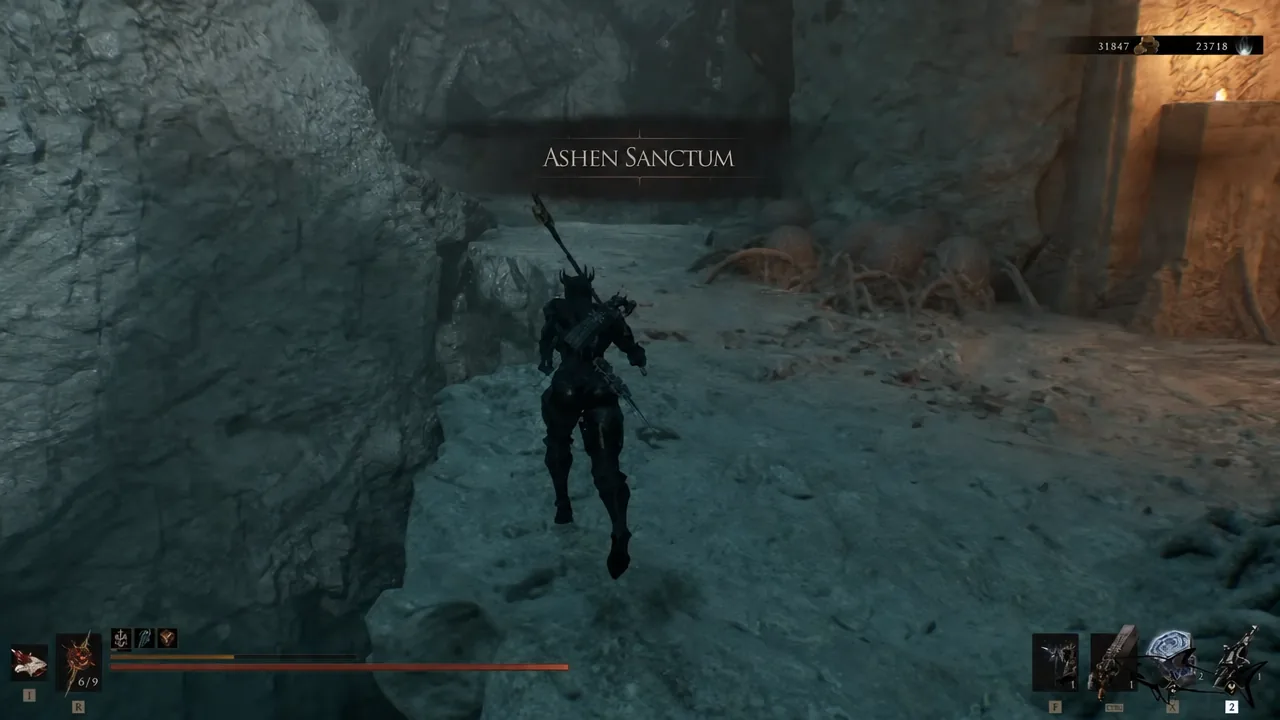 The Ashen Sanctum location title card appears as the player pushes forward through the cavern.