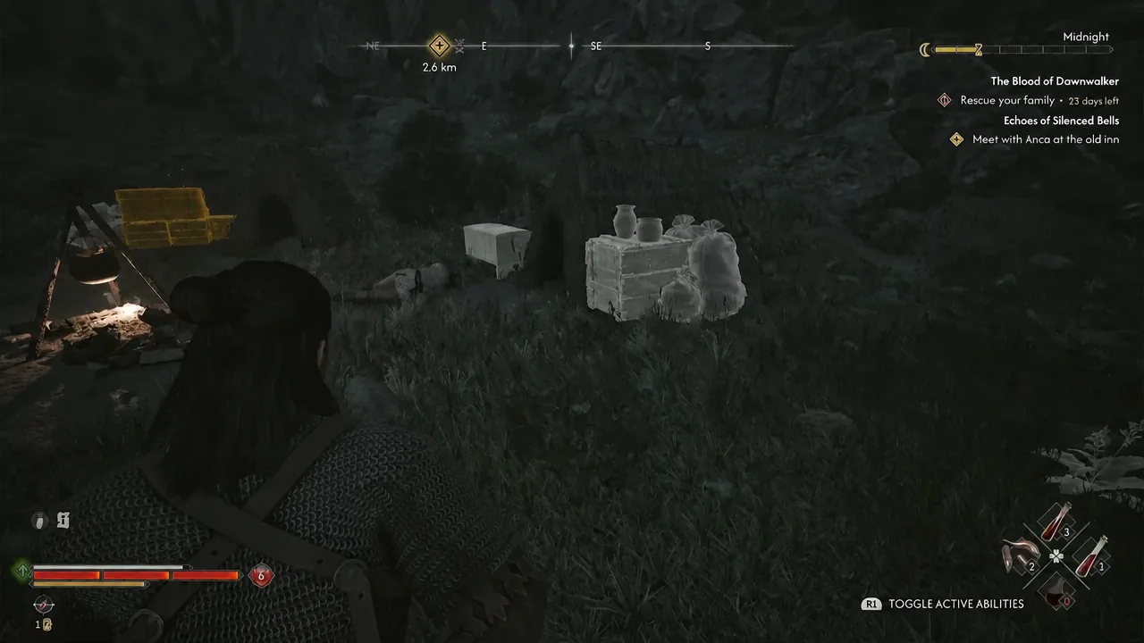 Lootable containers and a sack highlight as you walk up to them in the cleared camp.