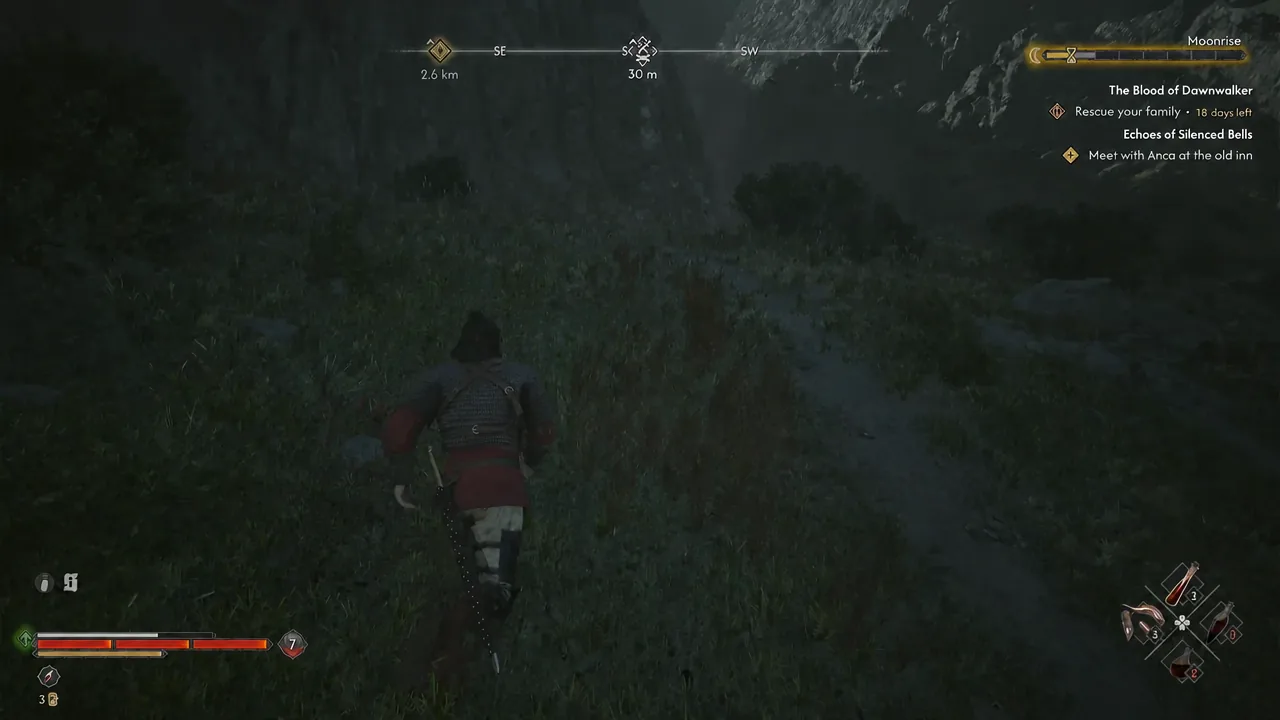Night-time travel toward the bandit camp with the quest tracker visible on the right side of the screen