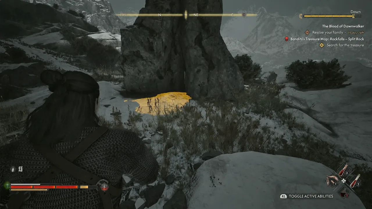 Snowy Rockfalls ground glowing yellow next to the split boulder, marking the buried stash