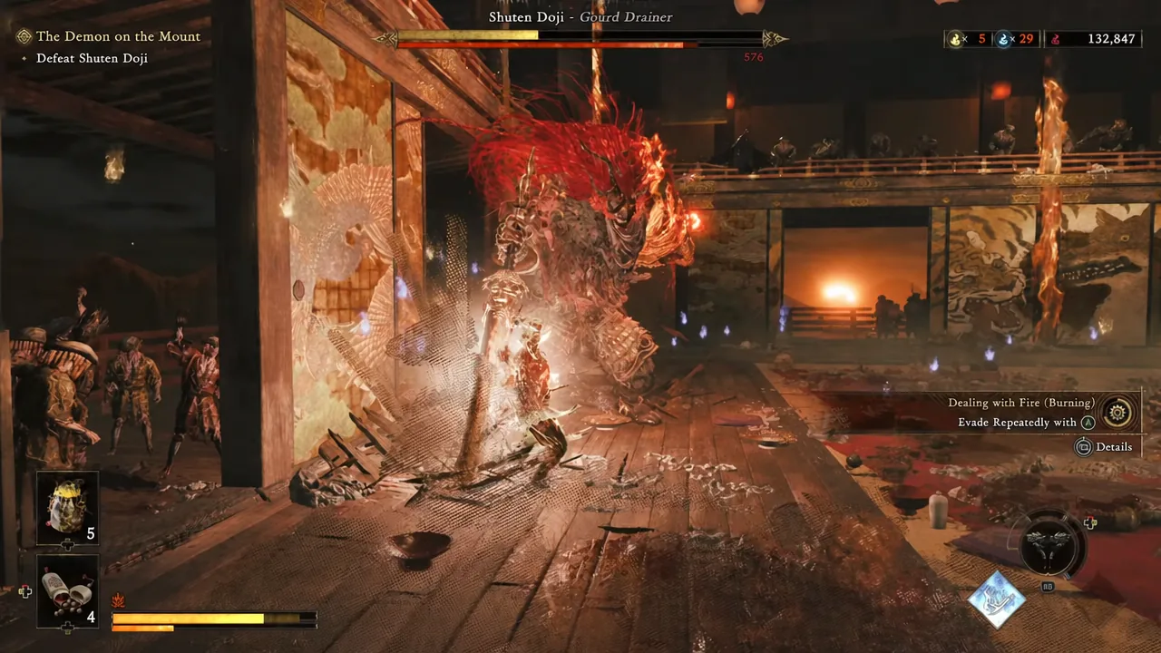On-screen Dealing with Fire prompt telling the player to evade repeatedly to put out the Burning status