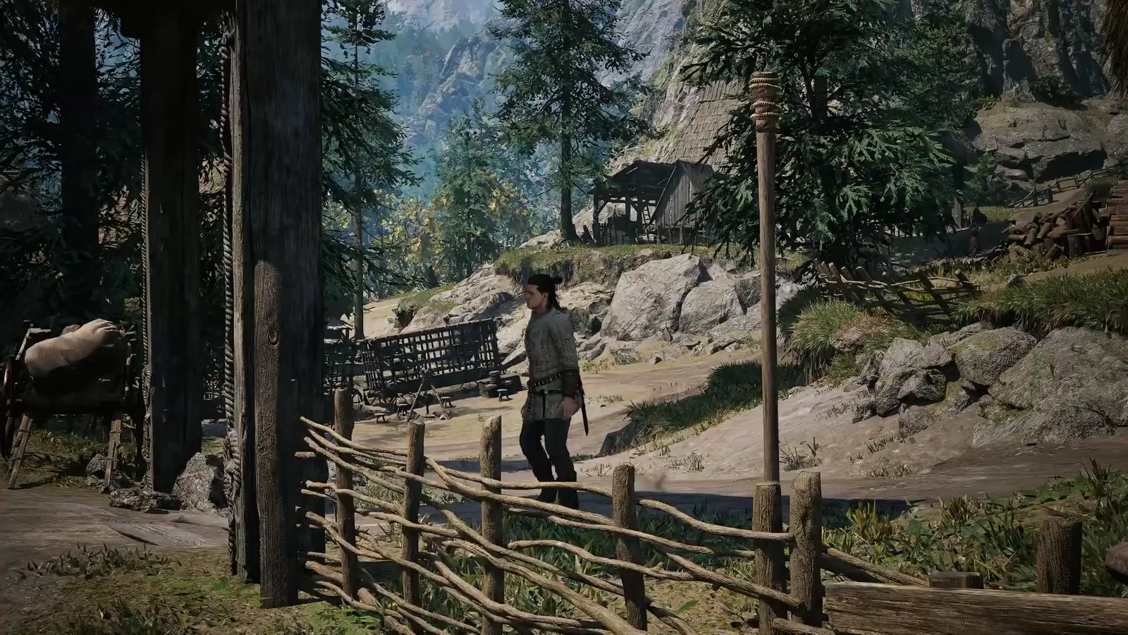 Coen approaches Vasil, who is sitting alone outside a wooden log cabin