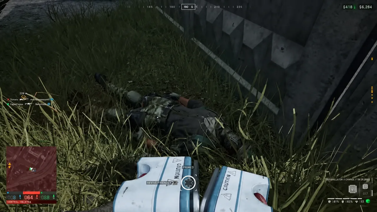 The REVIVE FRIENDLY prompt highlighted as a player uses defibrillator paddles on a downed teammate