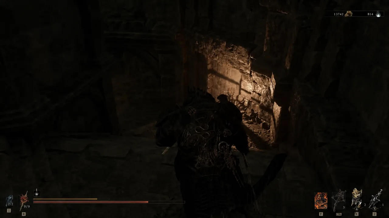 The stone corridor at the bottom of the lift, leading into the main Besieged Ruins chamber.