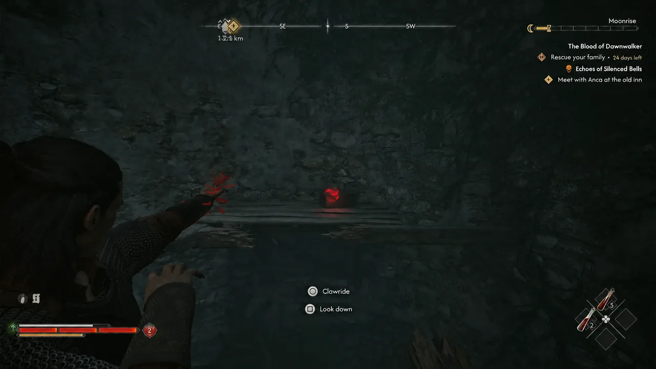 Interaction prompts on screen while the player lines up with a glowing red container in a cavern