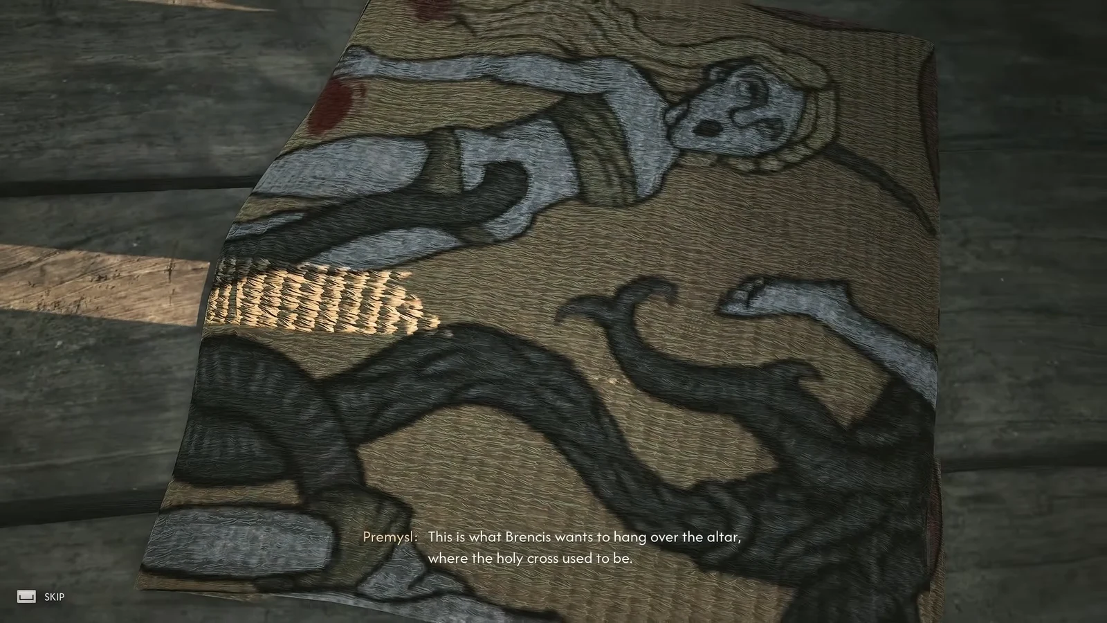 Premysl holding up the painted banner while subtitles explain Brencis wants it hung over the altar