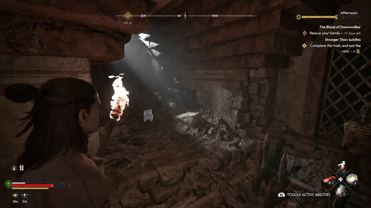 Coen holding a lit torch while moving through the ruins with the R1 ability prompt visible