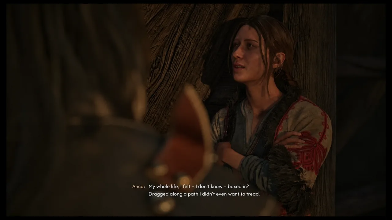 Anca speaking to Coen in close-up during the cabin scene, subtitles on screen