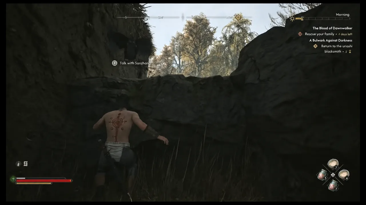 Quest tracker showing the Sanzhana objective while Coen climbs a rocky ledge near the cave